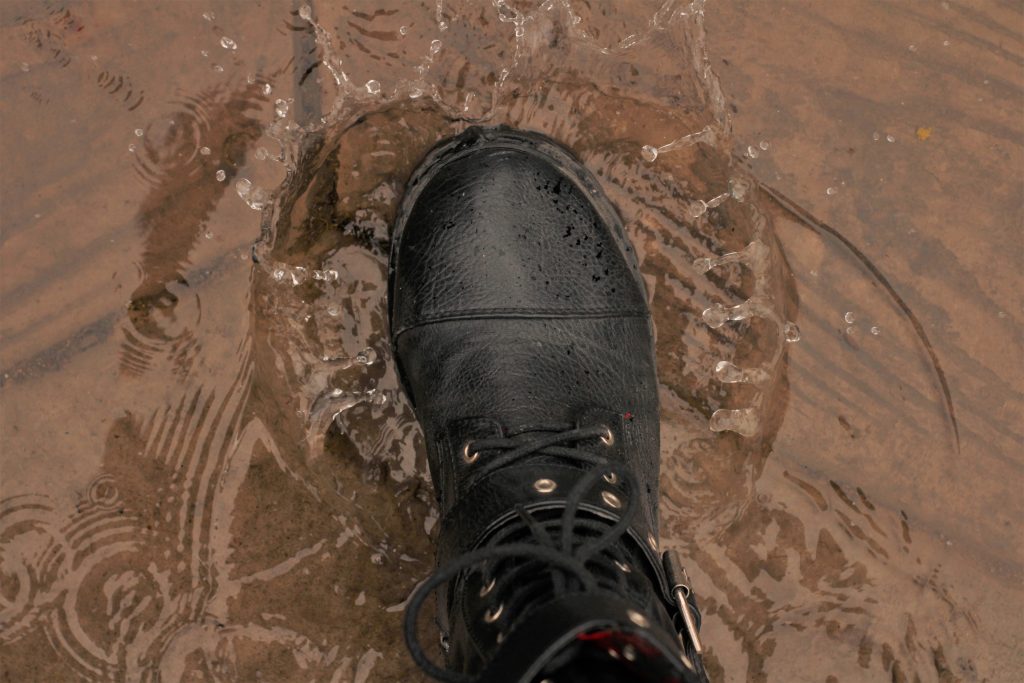 boot stomping in puddle